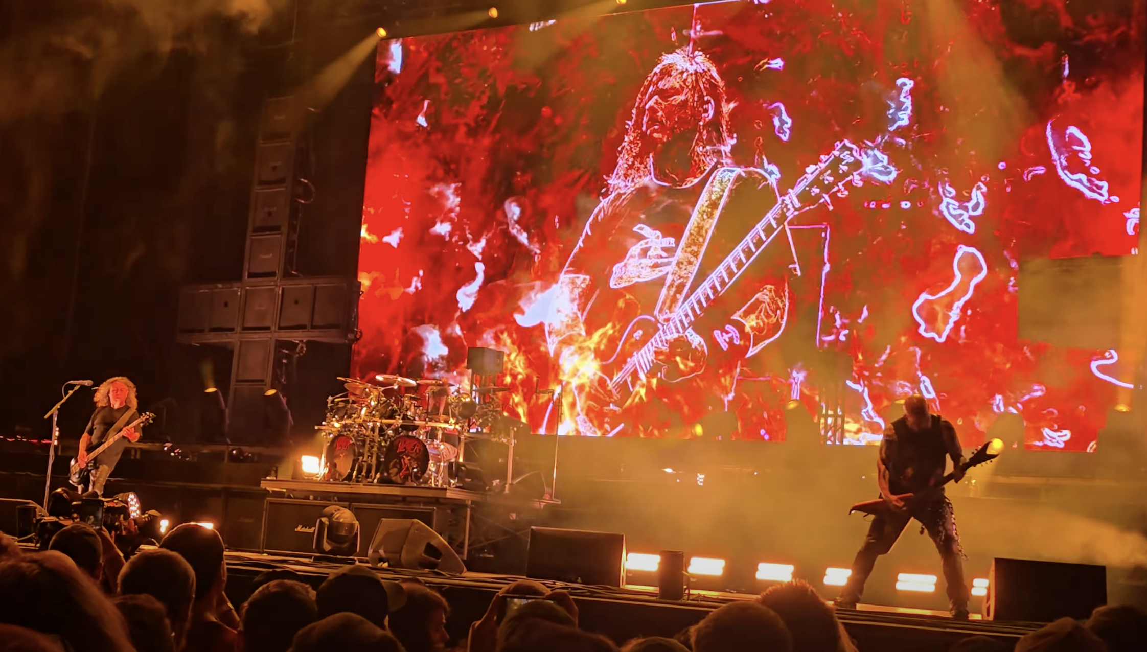 A photo of Slayer playing live.