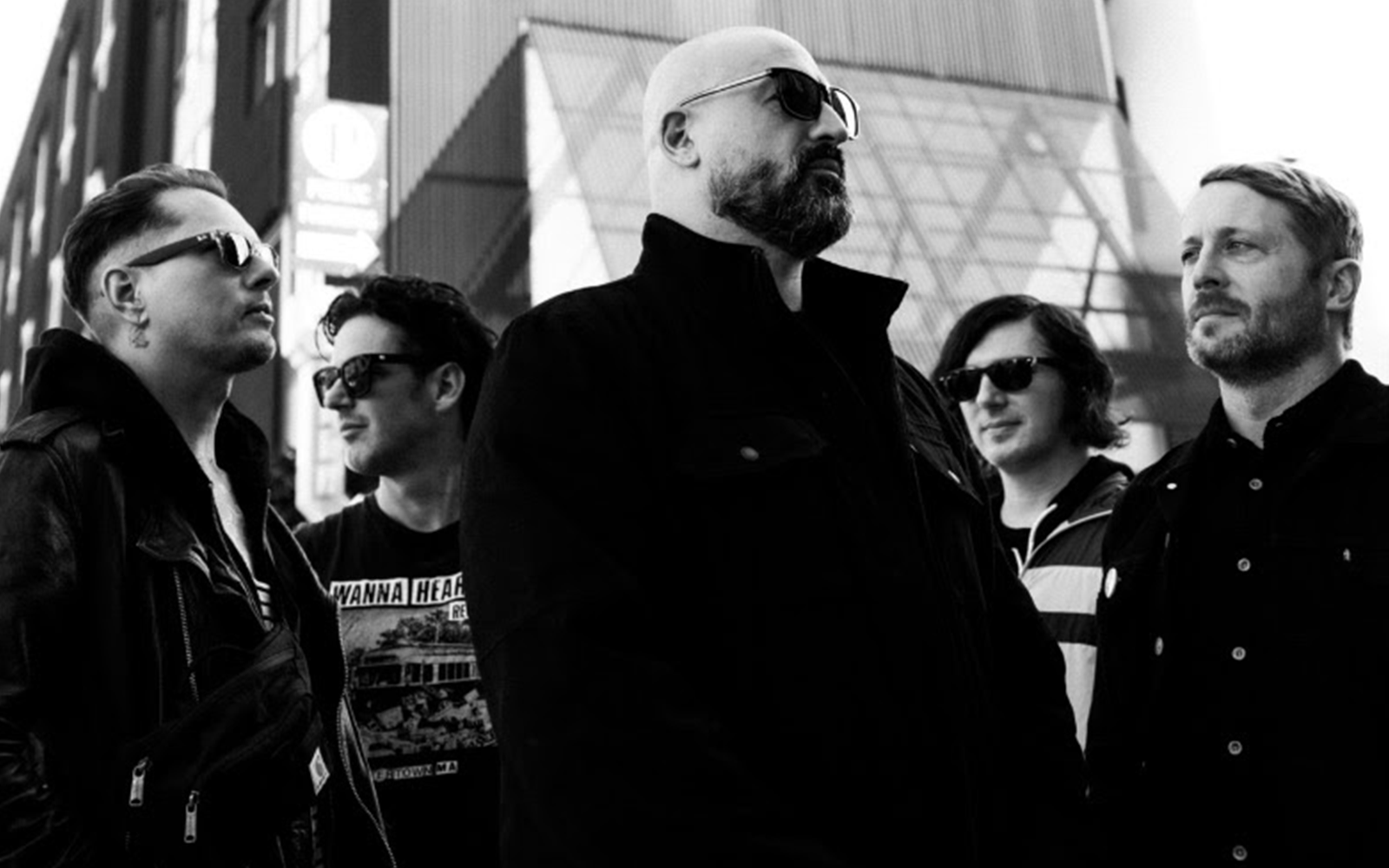 Studio promotional photo of Poison The Well, photographed by Sarai Kelley, featuring the band members posed together against a neutral backdrop.