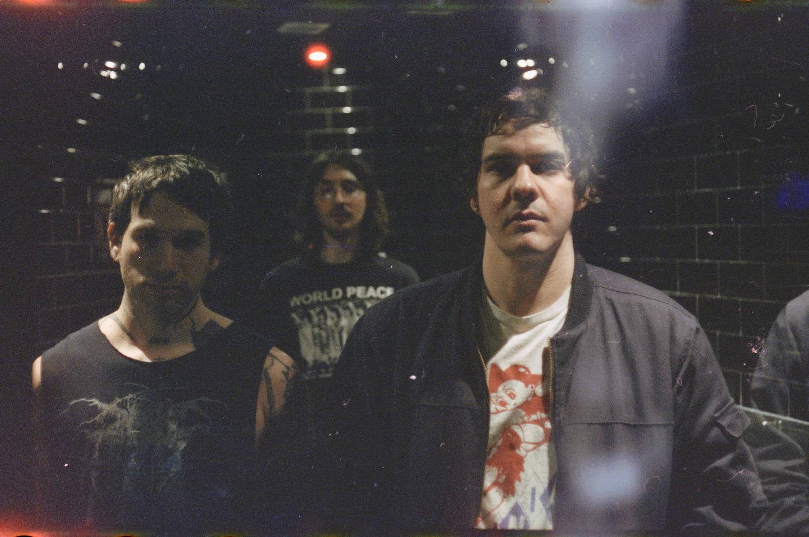 Promotional photo of Portrayal Of Guilt with members Matt King (vocals/guitar), Alex Stanfield (bass), and James Beveridge (drums), photographed by Craig Murray.