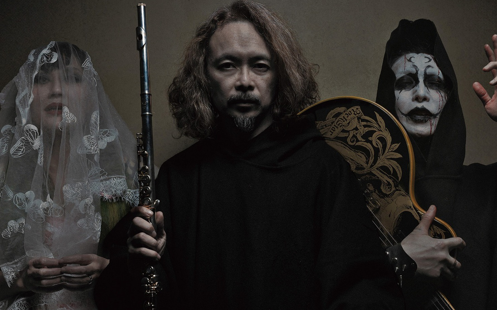 Sigh band studio portrait showing members posing together with instruments and dark atmospheric background