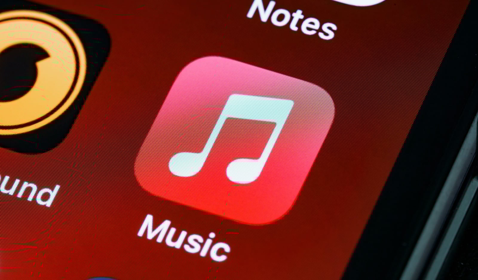 Smartphone screen showing the Apple Music app interface with album art, playlists, and playback controls.